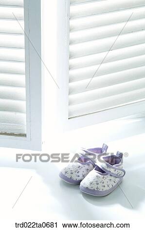 baby supplies/a baby shoe in front of a window View Large Photo Image Stock Image - baby supplies/a baby shoe in front of a window. Fotosearch