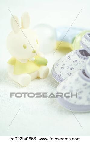 Stock Photograph - baby supplies/a babyshoe and a rabbit doll. Fotosearch