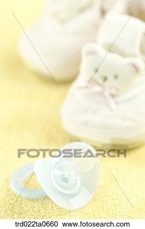 baby supplies/a nipple and a babyshoe View Large Photo Image Stock Image - baby supplies/a nipple and a babyshoe. Fotosearch