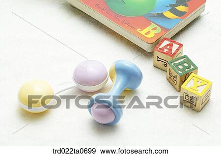 Stock Photo - baby supplies/fairy tale book, alphabet blocks and a noisemaker . Fotosearch
