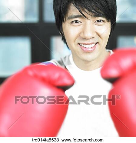 a man wearing boxing gloves View Large Photo Image Stock Photo - a man wearing boxing gloves. Fotosearch