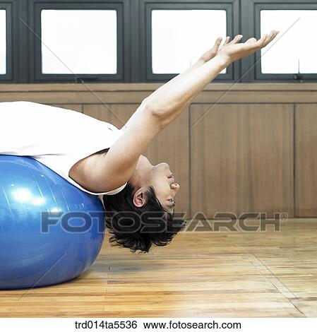 a stretching man with a ball View Large Photo Image Stock Photograph - a stretching man with a ball. Fotosearch