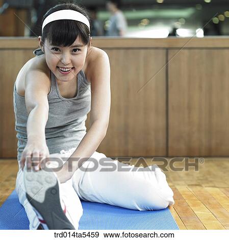 Stock Photo - a stretching woman at a fitness club. Fotosearch