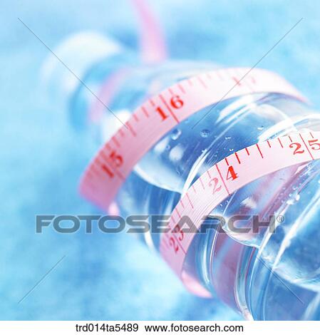 Stock Photo - a water bottle and a ruler. Fotosearch