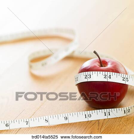 an apple and a ruler View Large Photo Image Stock Photography - an apple and a ruler. Fotosearch