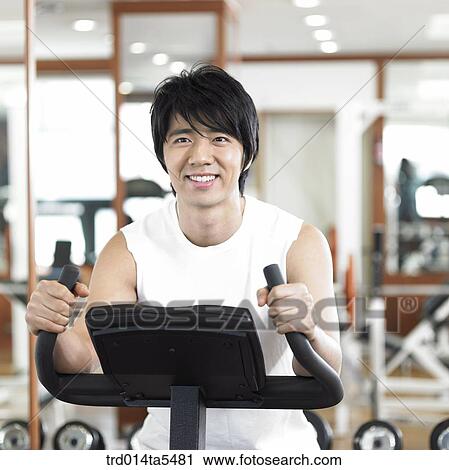 Stock Image - an exercising man at a fitness club. Fotosearch