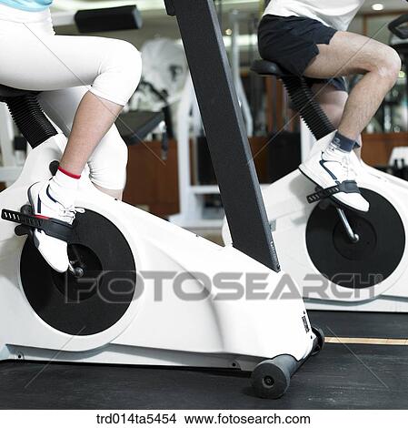 Picture - exercising people at a fitness club. Fotosearch