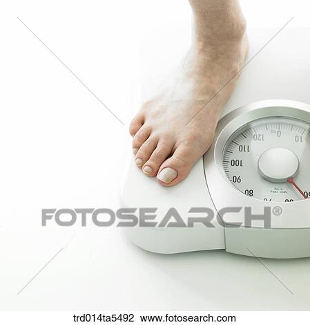Stock Image - measuring one's weight. Fotosearch