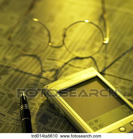business article/ a PDA and a pen on a newspaper View Large Photo Image Stock Image - business article/ a PDA and a pen on a newspaper. Fotosearch