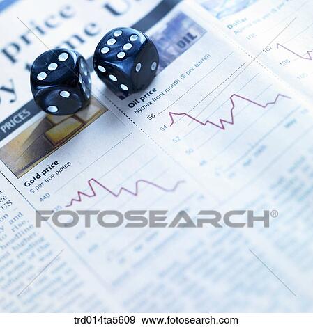 business article/a die on a newspaper View Large Photo Image Stock Photo - business article/a die on a newspaper. Fotosearch