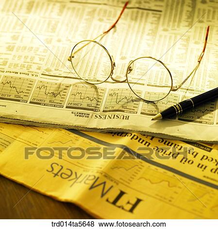 Stock Photo - business article/a newspaper and a glasses pen. Fotosearch