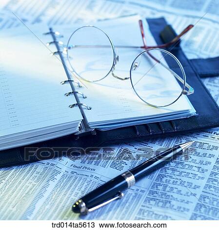 Stock Image - business article/a officeware on a newspaper. Fotosearch