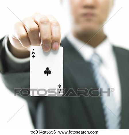 Stock Photograph - business concept/a businessman holding an ace card. Fotosearch