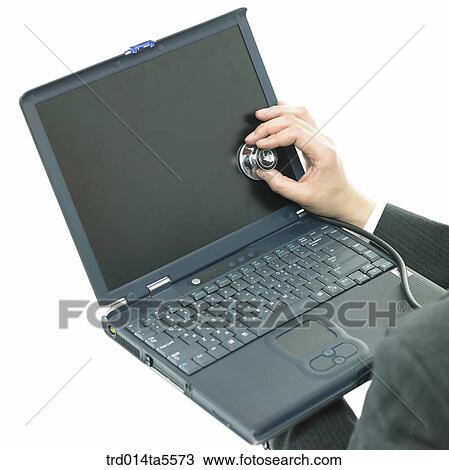 Stock Image - business concept/a businessman examining a notebook. Fotosearch