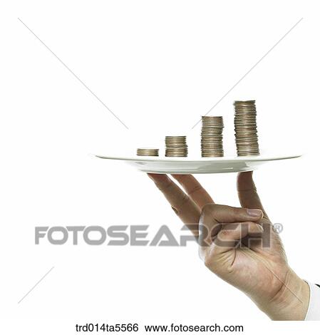 business concept/a businessman's hand holding a coin tower on a dish View Large Photo Image Stock Photograph - business concept/a businessman's hand holding a coin tower on a dish. Fotosearch