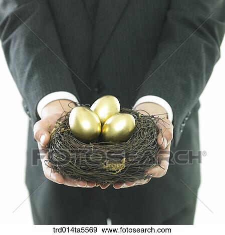 business concept/a businessman's hands holding a golden egg View Large Photo Image Stock Photo - business concept/a businessman's hands holding a golden egg. Fotosearch