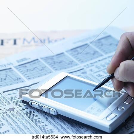 business concept/a PDA and an electric pen on a newspaper View Large Photo Image Picture - business concept/a PDA and an electric pen on a newspaper. Fotosearch