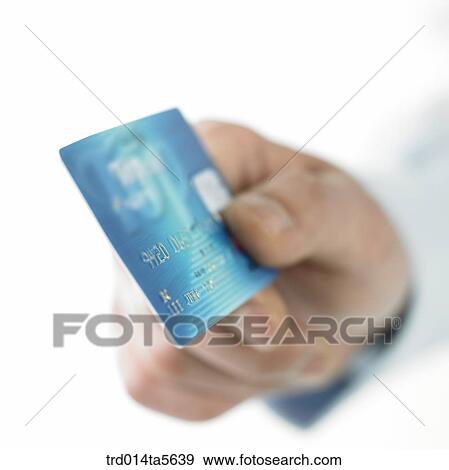 Stock Photo - finance/a hand holding a credit card. Fotosearch