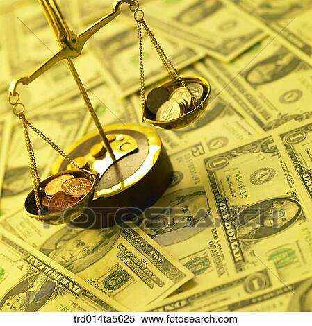 Stock Photography - finance/a scale and coins on a paper money . Fotosearch