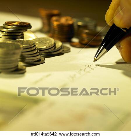 finance/coins and a hand making a signature View Large Photo Image Stock Image - finance/coins and a hand making a signature. Fotosearch