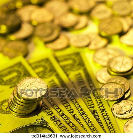 Stock Image - finance/coins on a paper money . Fotosearch