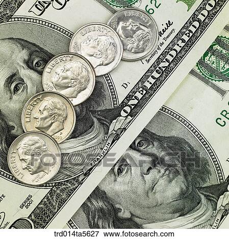 Stock Photo - finance/coins on a paper money . Fotosearch