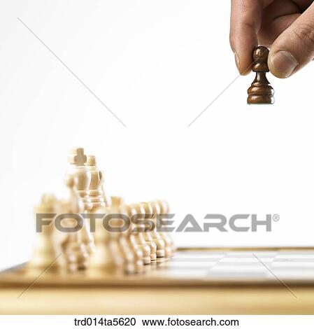 Stock Image - game/a hand holding a chess. Fotosearch