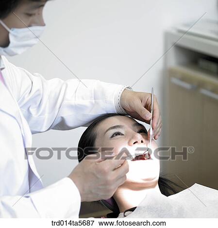Stock Photo - medicine/ a dentist and a patient. Fotosearch