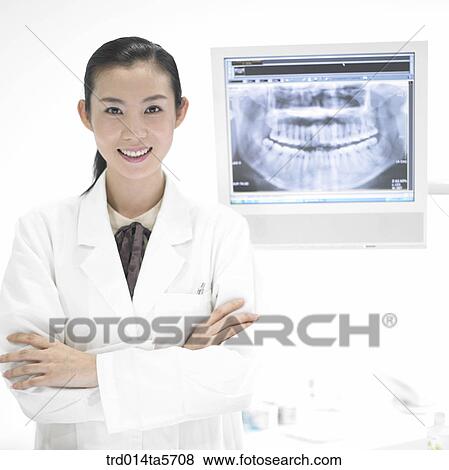 Stock Photo - medicine/ a dentist looking at X-ray photographs. Fotosearch