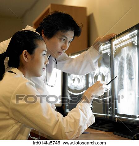 medicine/ a dentist looking at X-ray photographs View Large Photo Image Stock Photograph - medicine/ a dentist looking at X-ray photographs. Fotosearch
