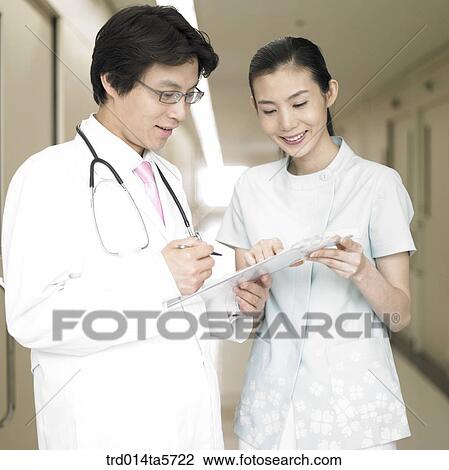 medicine/ a doctor and a nurse holding a medical chart View Large Photo Image Stock Image - medicine/ a doctor and a nurse holding a medical chart. Fotosearch