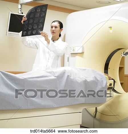 medicine/ a doctor and a patient looking at MRI pictures View Large Photo Image Picture - medicine/ a doctor and a patient looking at MRI pictures. Fotosearch