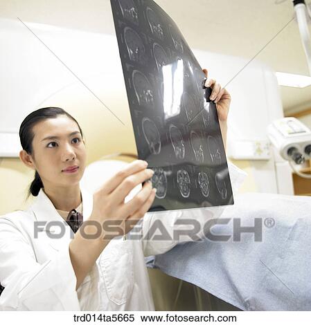 medicine/ a doctor and a patient looking at MRI pictures View Large Photo Image Stock Photography - medicine/ a doctor and a patient looking at MRI pictures. Fotosearch