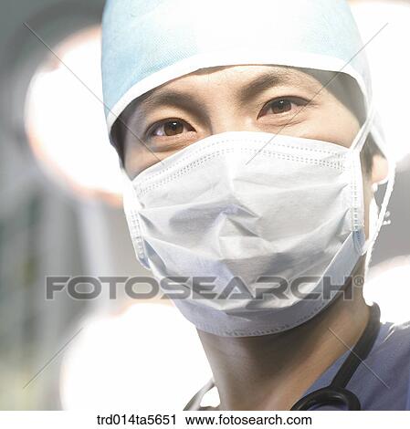 Stock Image - medicine/ a doctor in an operating room. Fotosearch
