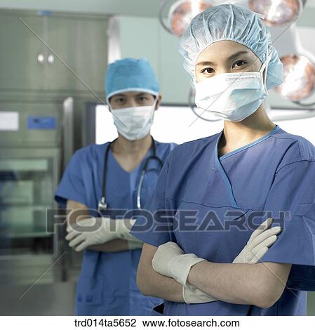 Stock Image - medicine/ a doctor in an operating room. Fotosearch