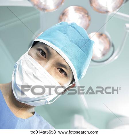 Stock Image - medicine/ a doctor in an operating room. Fotosearch