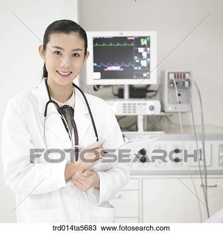 Stock Image - medicine/ a doctor in front of a medical equipment. Fotosearch