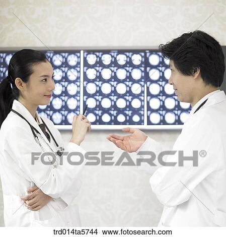 medicine/ a doctor looking at MRI pictures View Large Photo Image Picture - medicine/ a doctor looking at MRI pictures. Fotosearch