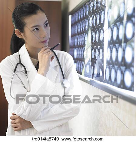 medicine/ a doctor looking at MRI pictures View Large Photo Image Stock Image - medicine/ a doctor looking at MRI pictures. Fotosearch
