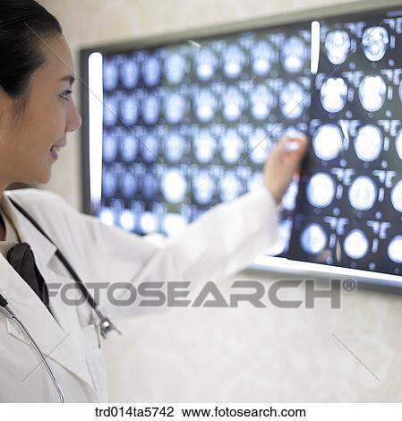 medicine/ a doctor looking at MRI pictures View Large Photo Image Stock Image - medicine/ a doctor looking at MRI pictures. Fotosearch