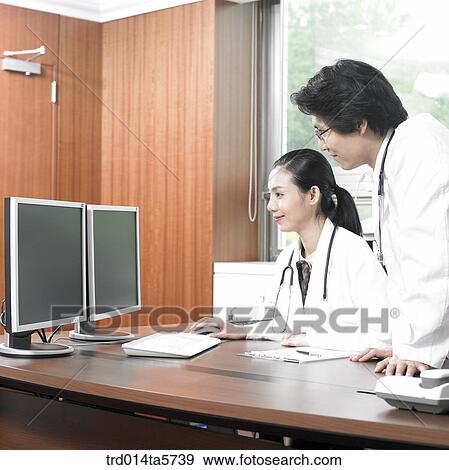 medicine/ a doctor using a computer View Large Photo Image Stock Photo - medicine/ a doctor using a computer. Fotosearch