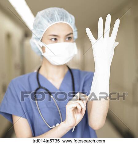 medicine/ a doctor wearing operating gloves View Large Photo Image Stock Photography - medicine/ a doctor wearing operating gloves. Fotosearch