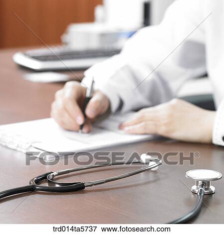medicine/ a doctor writing a medical chart View Large Photo Image Stock Photo - medicine/ a doctor writing a medical chart. Fotosearch