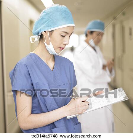 medicine/ a doctor writing a medical chart View Large Photo Image Stock Photo - medicine/ a doctor writing a medical chart. Fotosearch