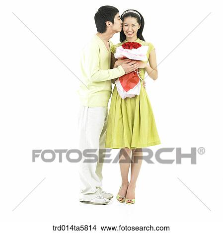 a boy giving a rose bouquet to his girl friend View Large Photo Image Picture - a boy giving a rose bouquet to his girl friend. Fotosearch