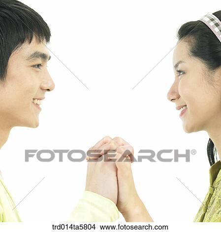 Picture - a couple holding hands. Fotosearch