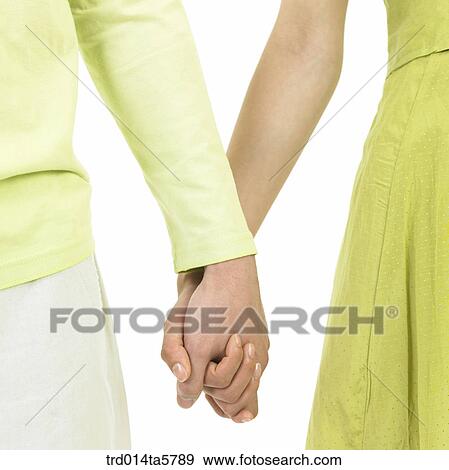 a couple holding hands View Large Photo Image Stock Photo - a couple holding hands. Fotosearch