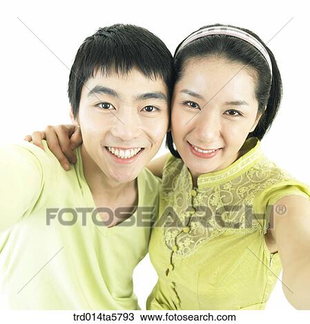 Stock Image - a couple taking a picture. Fotosearch