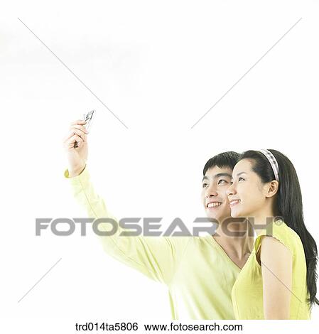 Stock Photograph - a couple taking a picture. Fotosearch