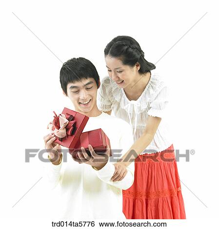 a couple with a gift View Large Photo Image Stock Photograph - a couple with a gift. Fotosearch